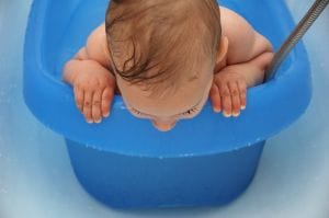 baby in blue bath tub