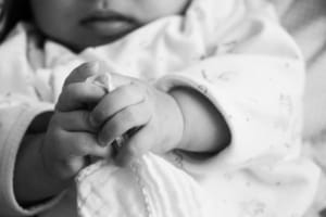 baby holding hands together