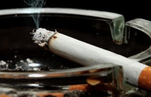 burning cigarette in ash tray