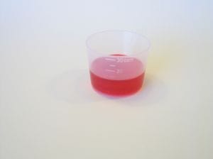 red cough medicine in cup
