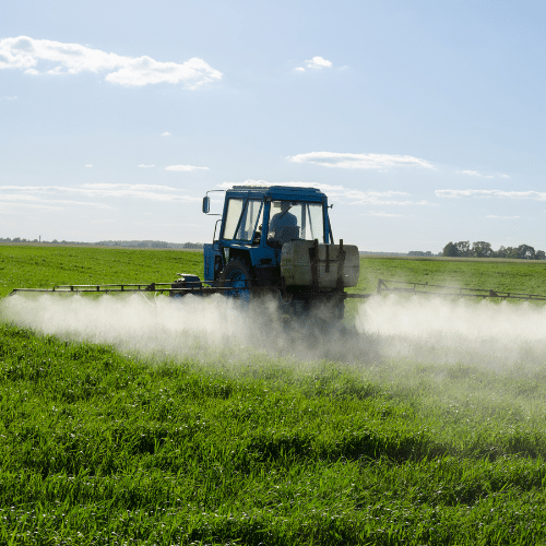 Man of Tractor Spraying Herbicide Paraquat